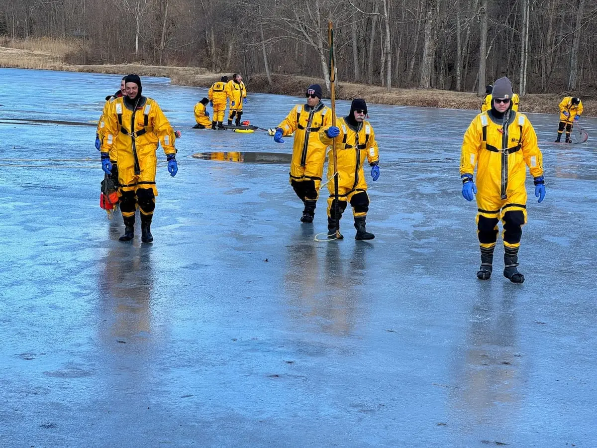 Mustang Suit Ice Rescue Training — Cold-water immersion suit and throw-bag rescue drills on a frozen pond in Ghent.